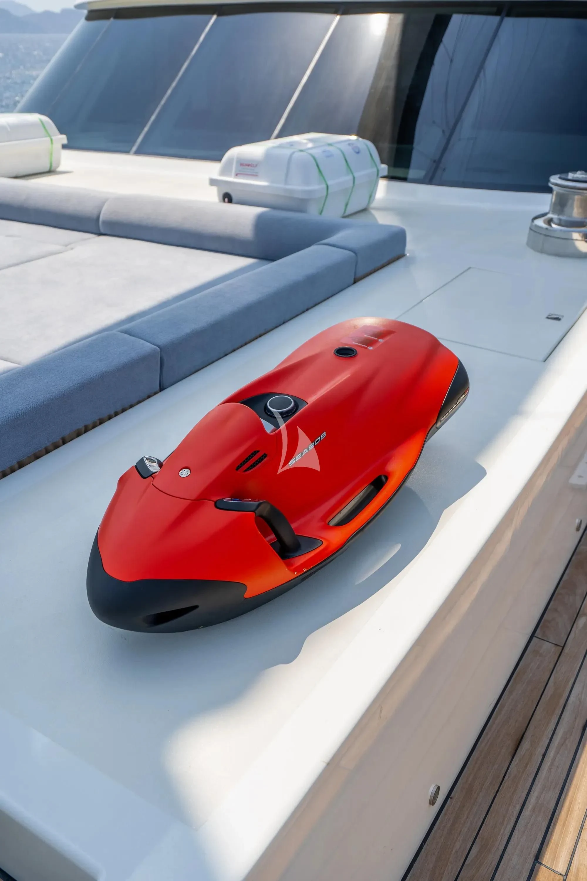 a red and black sports car on a white surface aboard DE LOVE Yacht for Charter