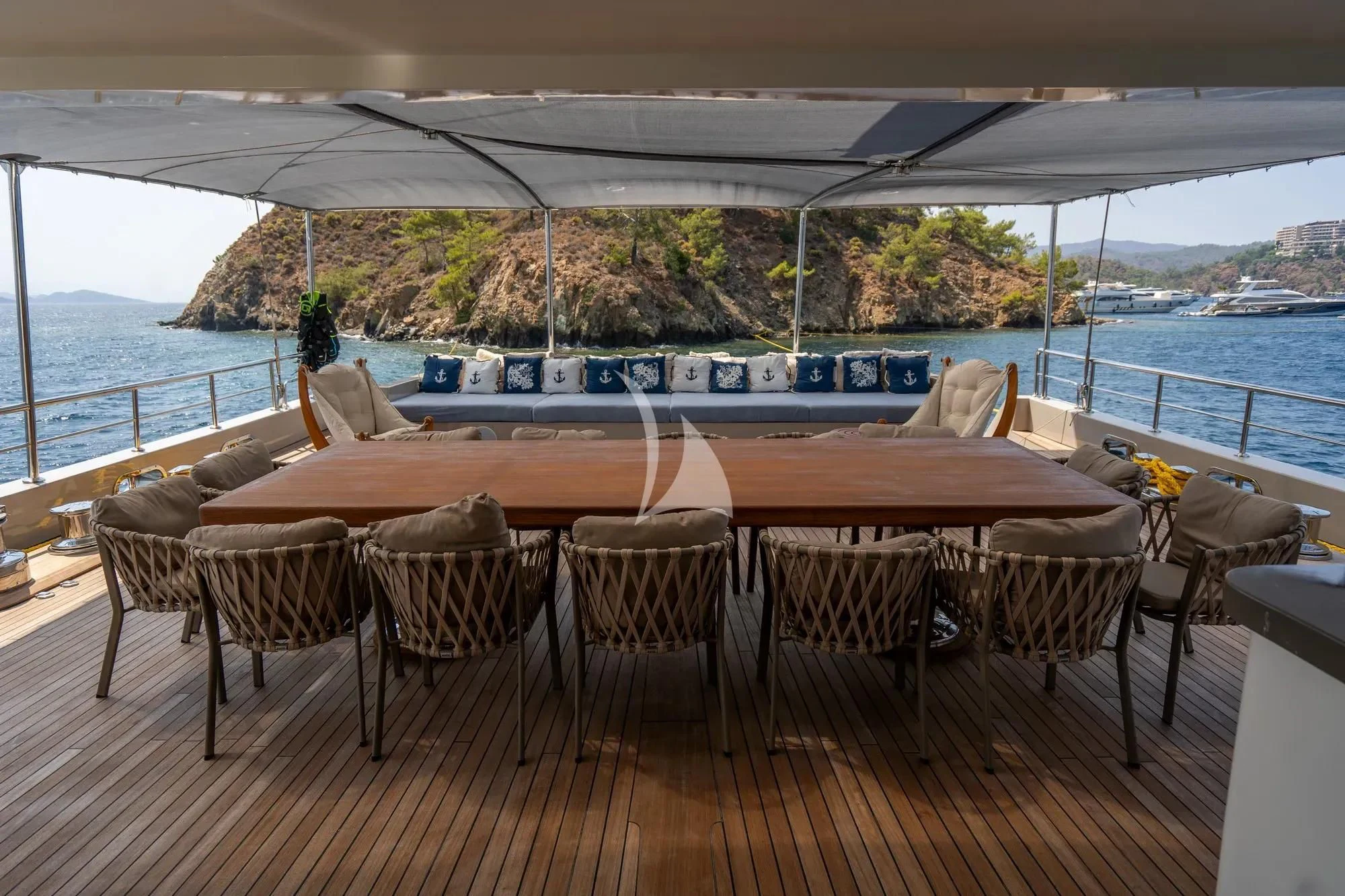 a group of tables and chairs on a deck overlooking a body of water aboard DE LOVE Yacht for Charter