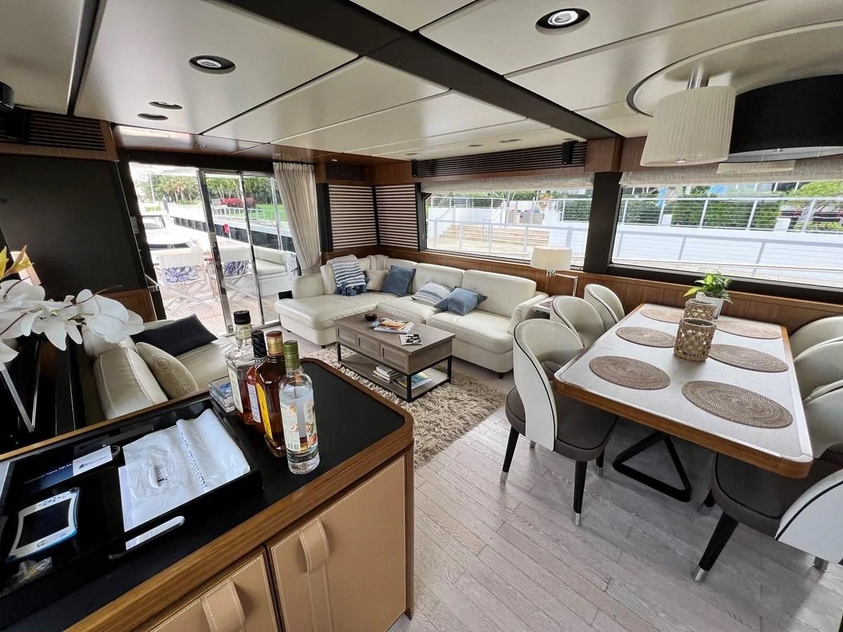a living room with a table and chairs aboard PURA VIDA Yacht for Sale