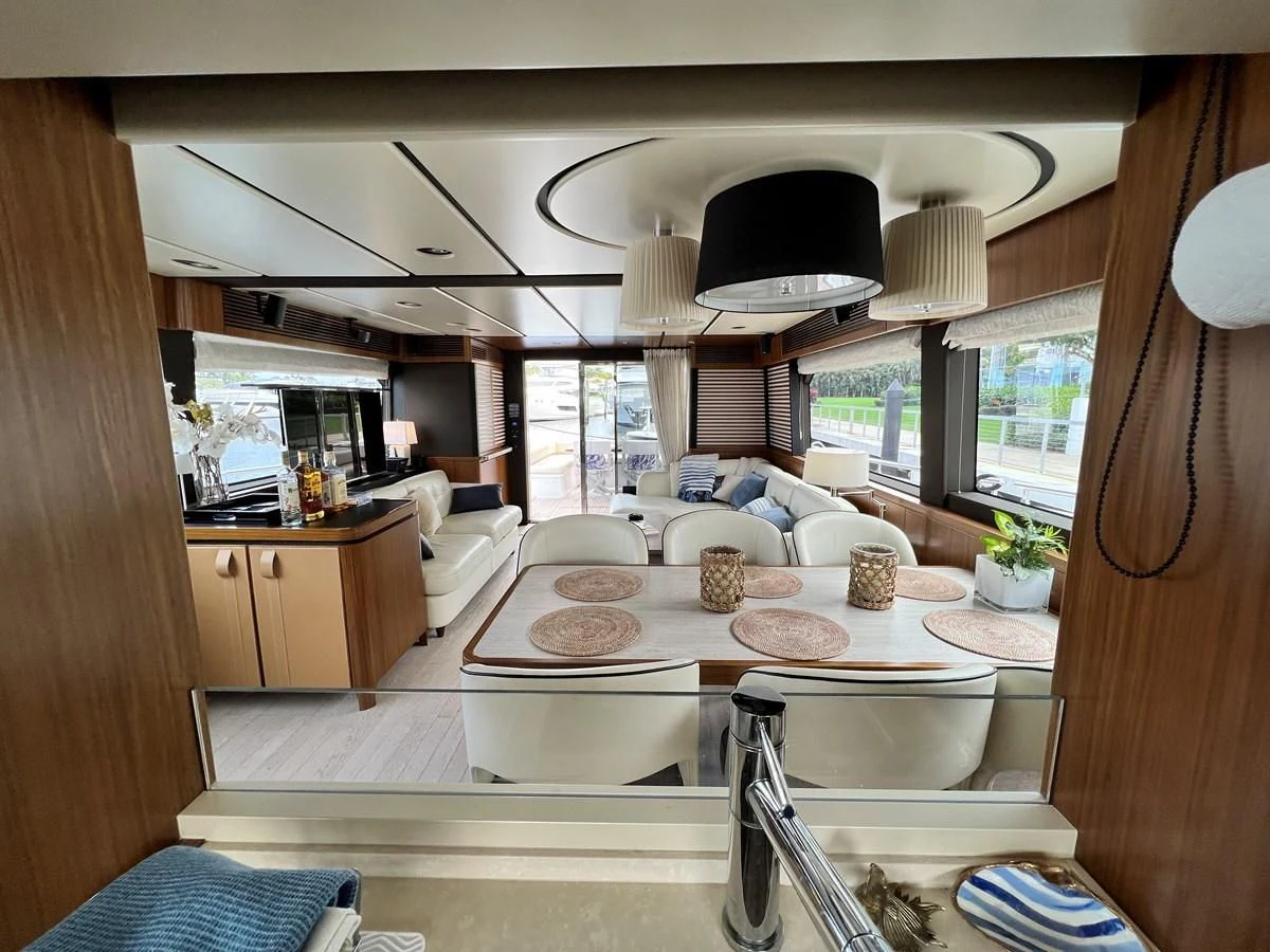 a living room with a large window aboard PURA VIDA Yacht for Sale