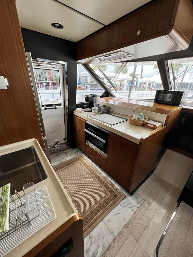 a kitchen with a large window aboard PURA VIDA Yacht for Sale