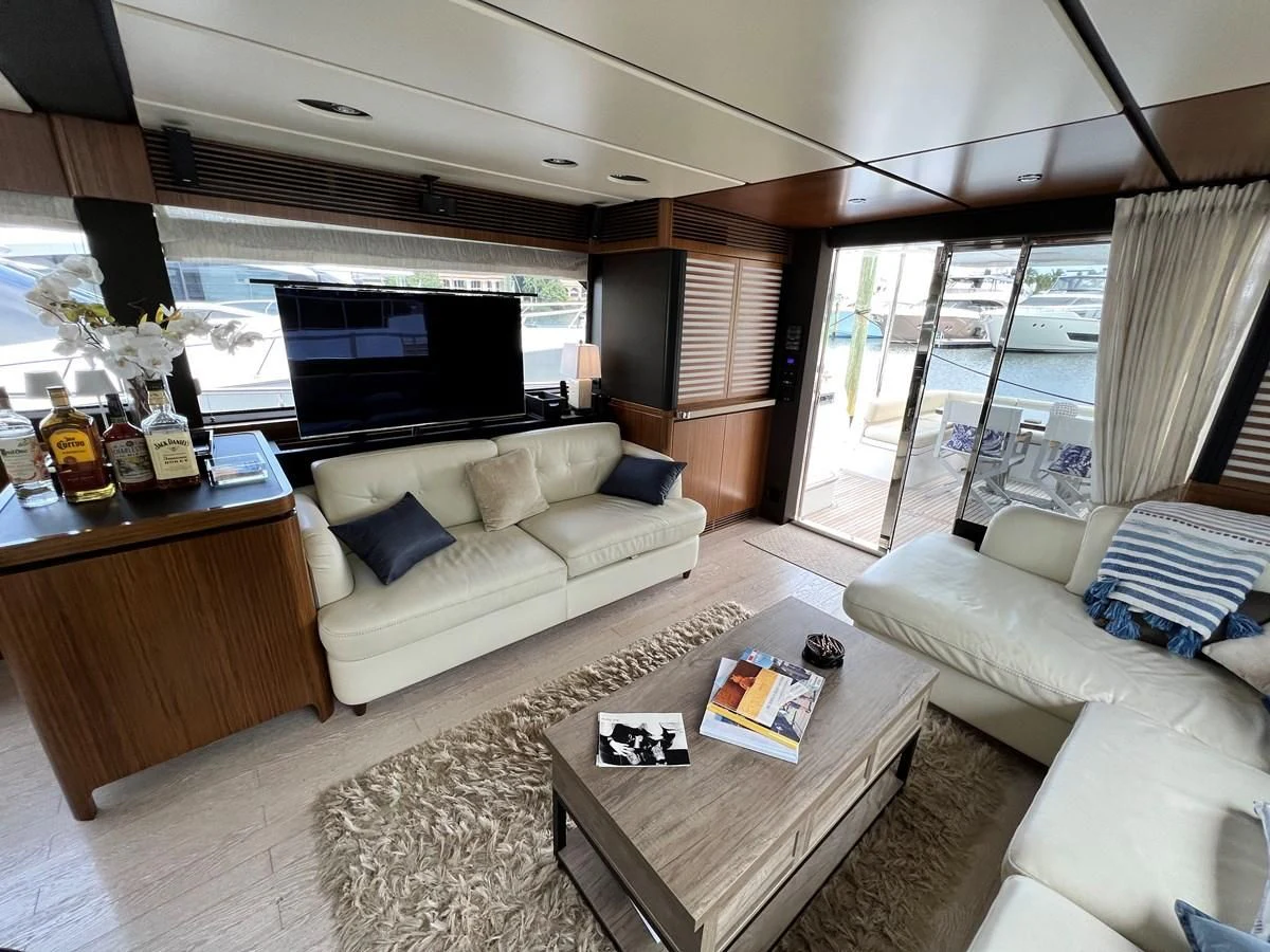a living room with a large window aboard PURA VIDA Yacht for Sale