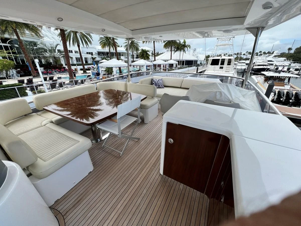 a boat with lounge chairs and umbrellas on a deck aboard PURA VIDA Yacht for Sale