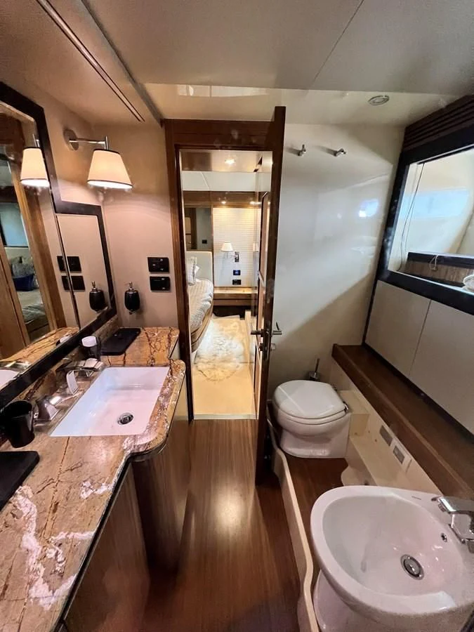 a bathroom with a sink and a toilet aboard PURA VIDA Yacht for Sale
