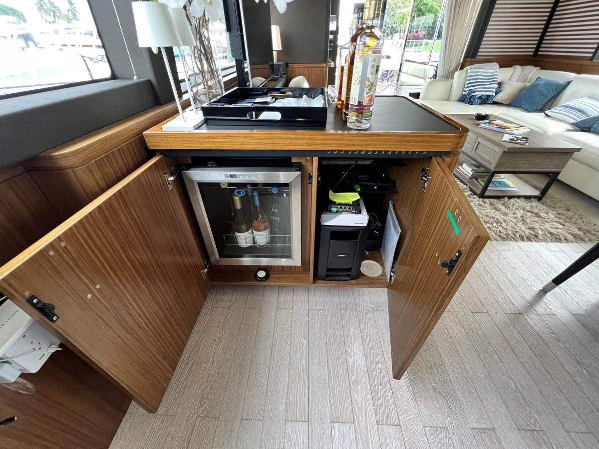 a room with a bed and a television aboard PURA VIDA Yacht for Sale