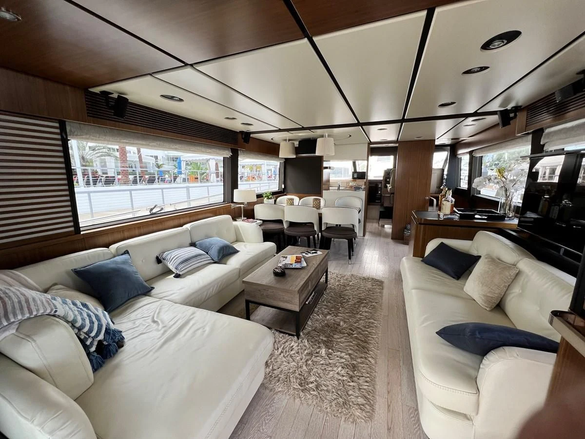 a living room with a couch and a table aboard PURA VIDA Yacht for Sale
