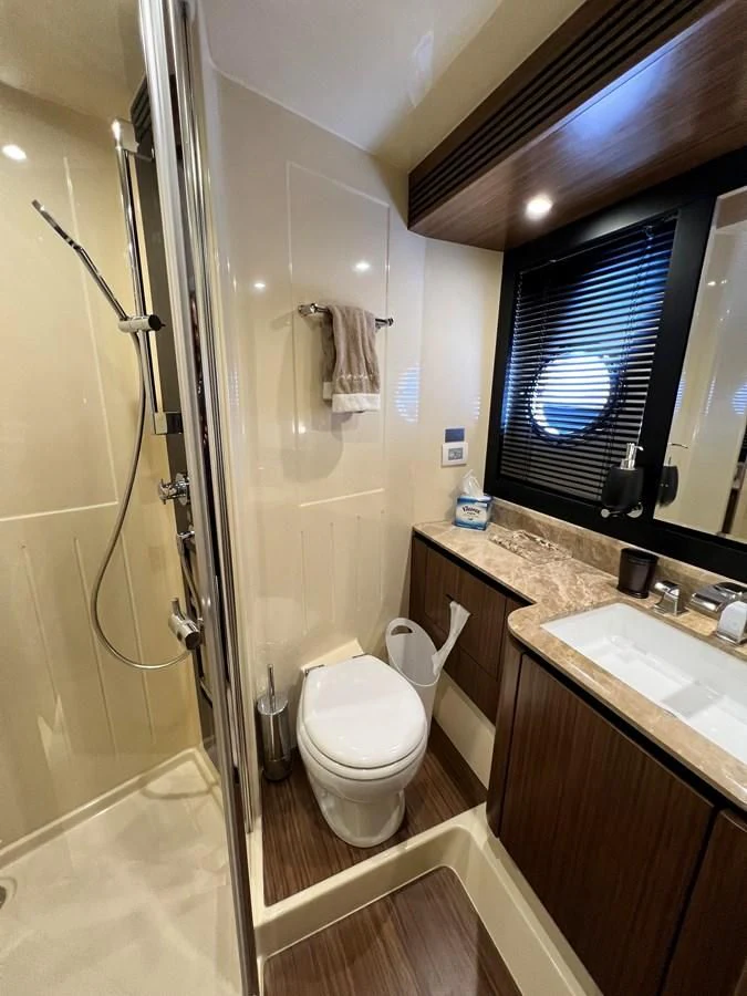 a bathroom with a glass shower door aboard PURA VIDA Yacht for Sale