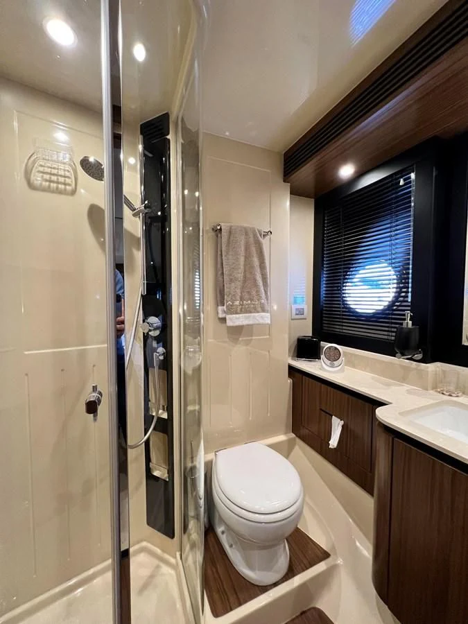 a bathroom with a glass shower aboard PURA VIDA Yacht for Sale