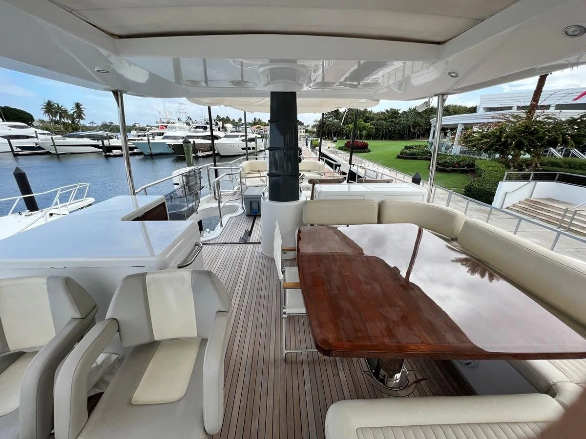 a room with a table chairs and a pool aboard PURA VIDA Yacht for Sale