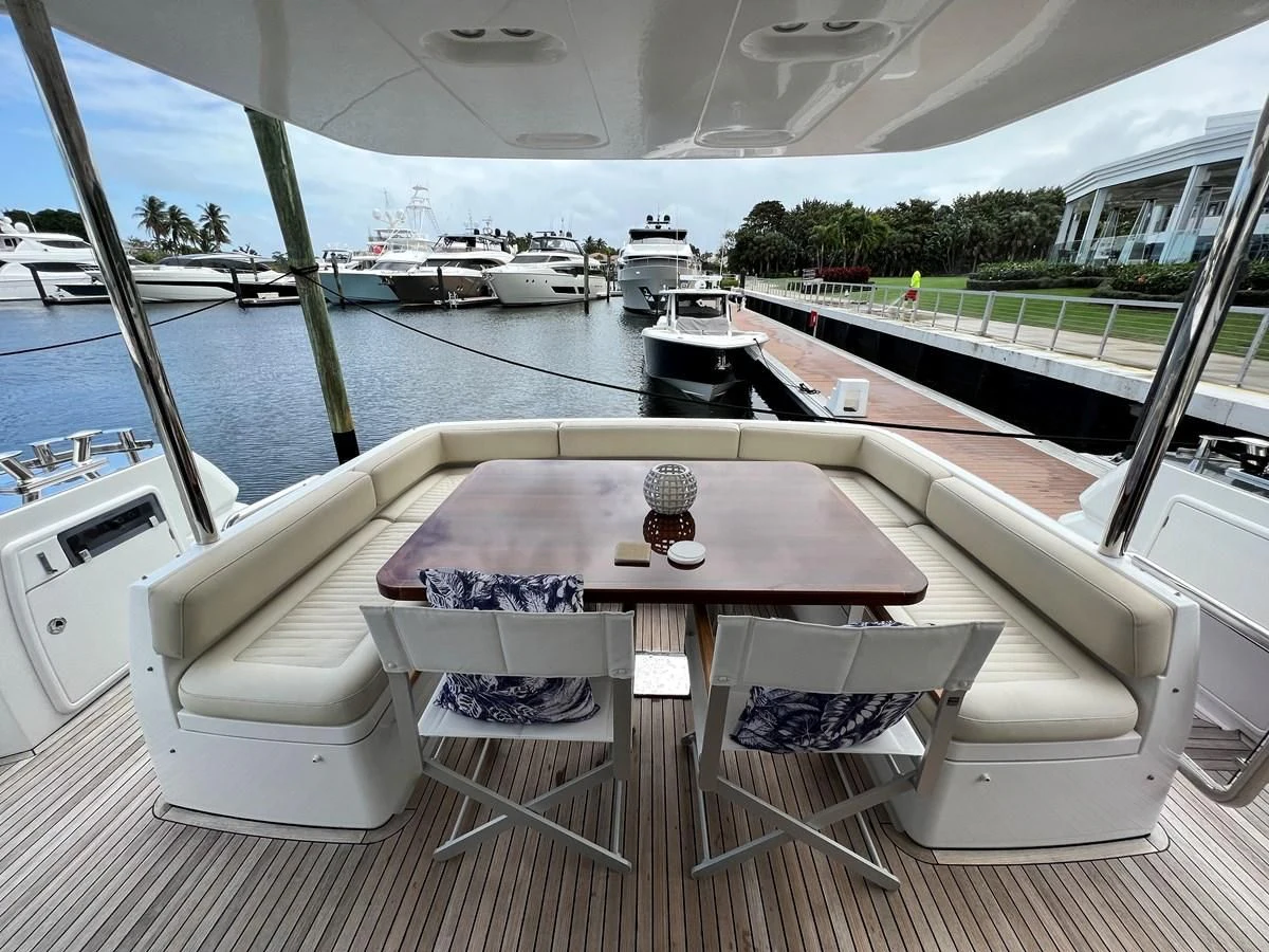 a table and chairs on a deck aboard PURA VIDA Yacht for Sale