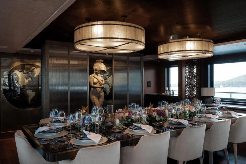 a large dining room with a gold statue aboard PINK SHADOW Yacht for Sale