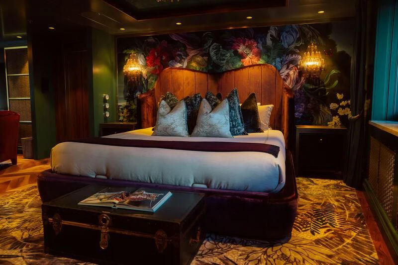 a bed with a blue and white bed spread aboard PINK SHADOW Yacht for Sale