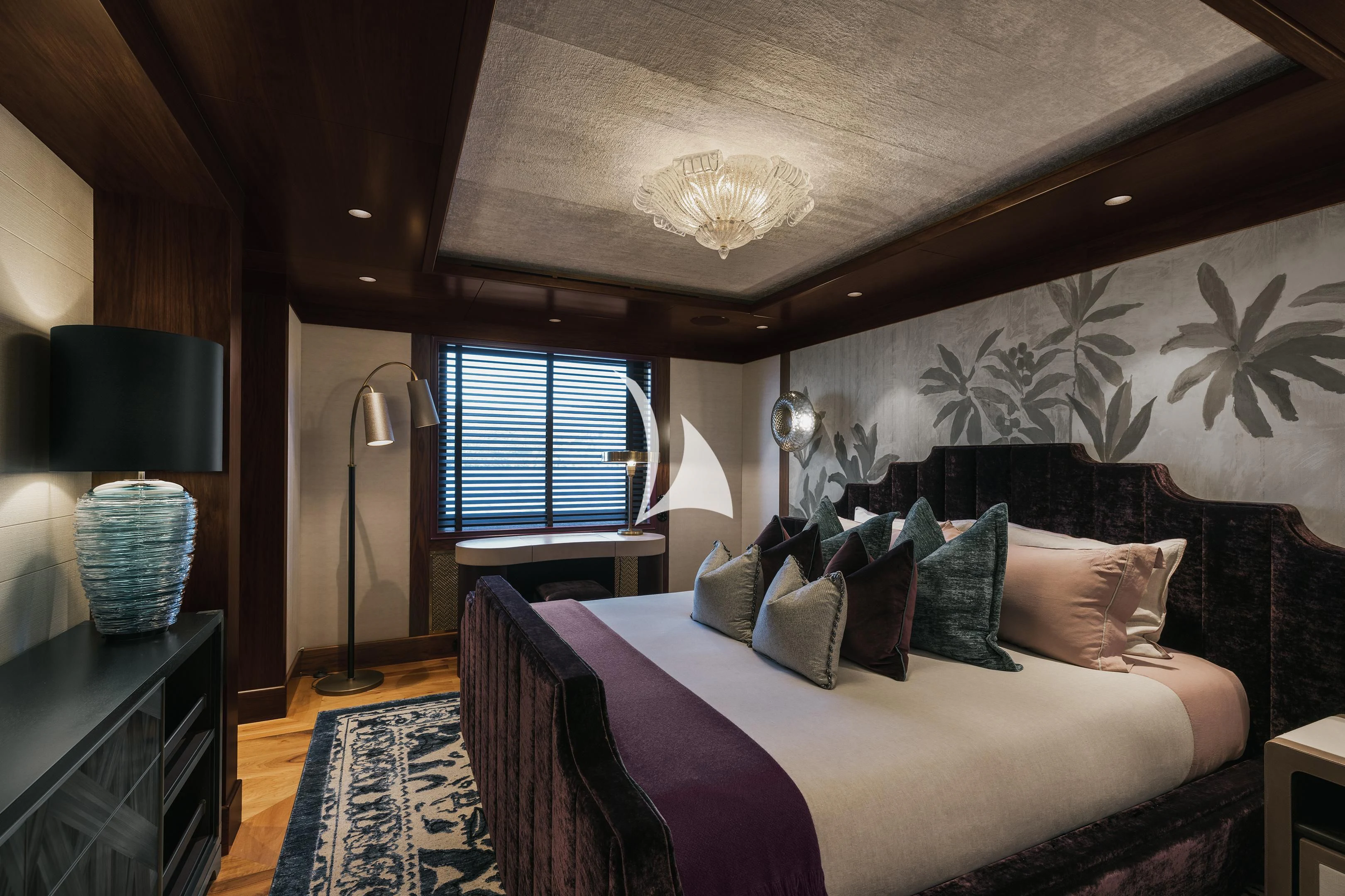 a bed with a purple and white bed spread aboard PINK SHADOW Yacht for Sale