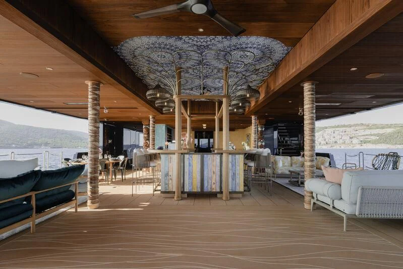 a covered patio with a large chandelier aboard PINK SHADOW Yacht for Sale
