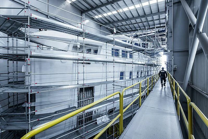 a person walking down a long hallway aboard PINK SHADOW Yacht for Sale