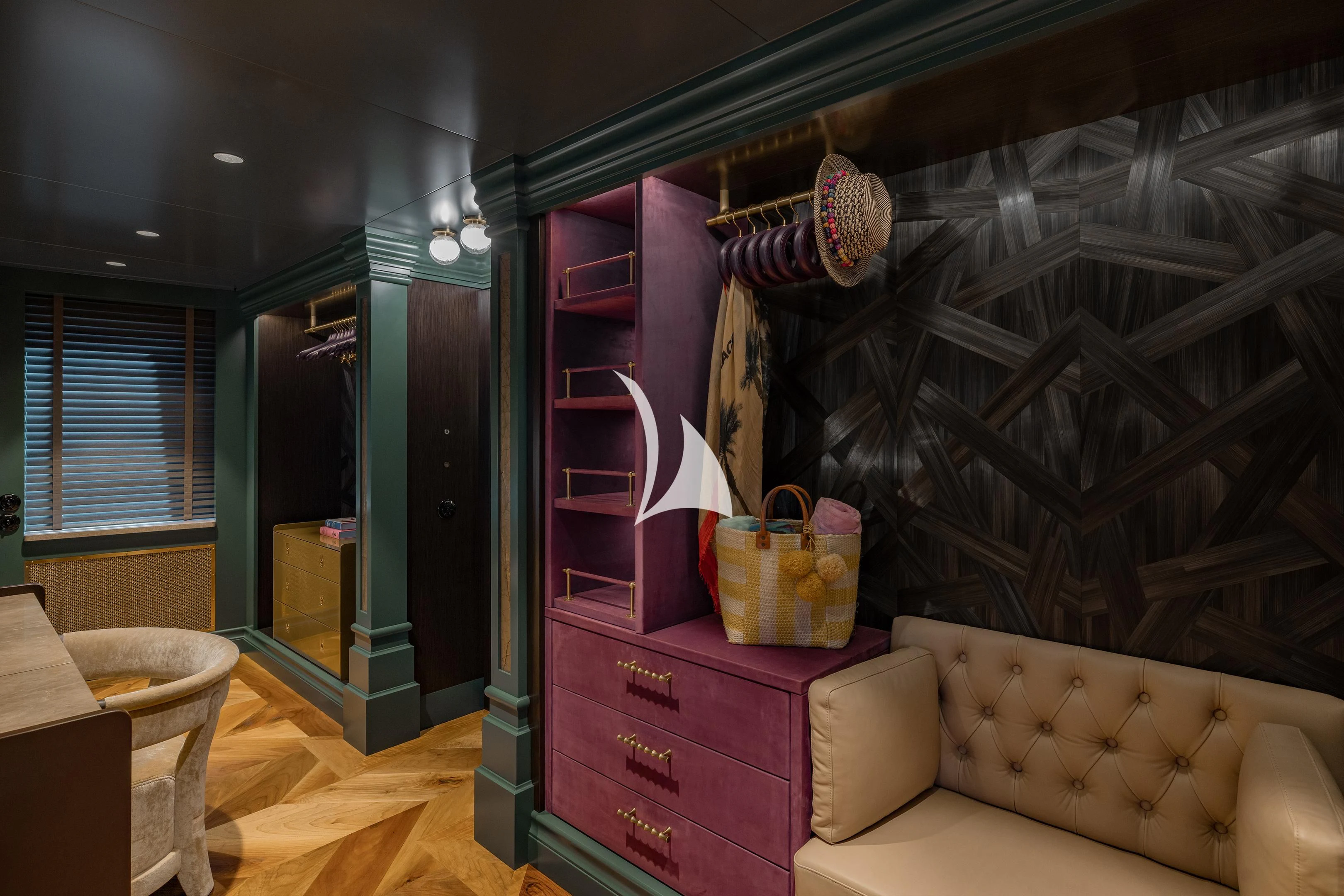 a room with a couch and a shelf with clothes from it aboard PINK SHADOW Yacht for Sale