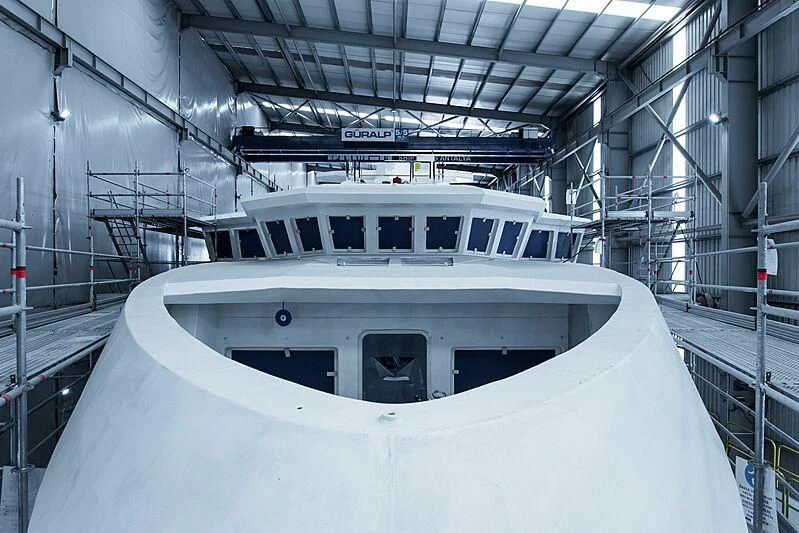 a white boat in a large building aboard PINK SHADOW Yacht for Sale