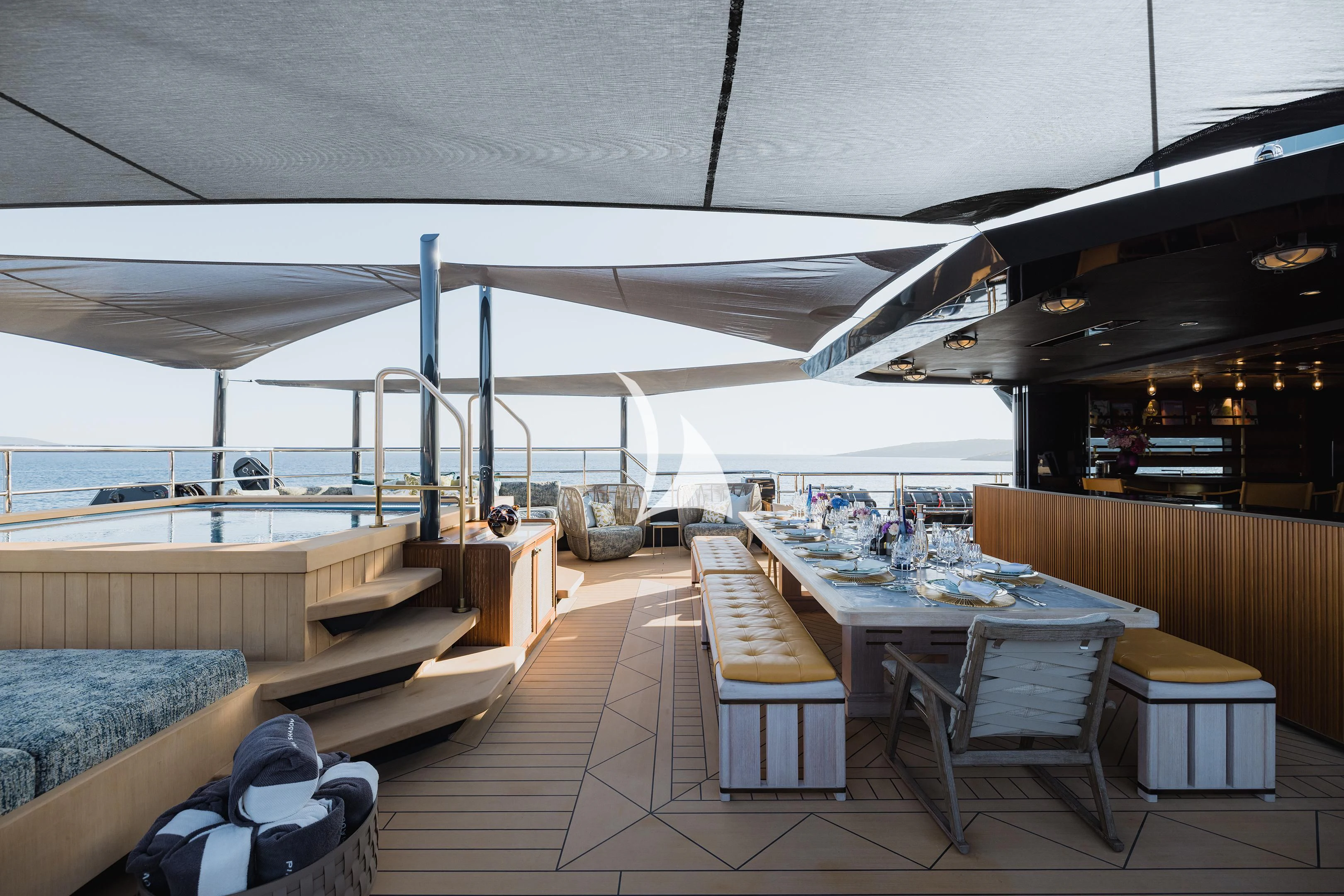 a patio with a table and chairs aboard PINK SHADOW Yacht for Sale