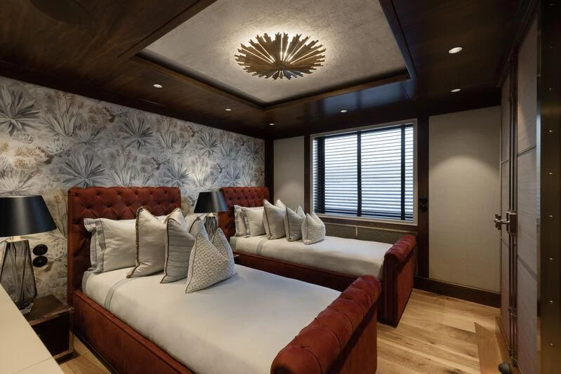 a bedroom with a bed and a window aboard PINK SHADOW Yacht for Sale