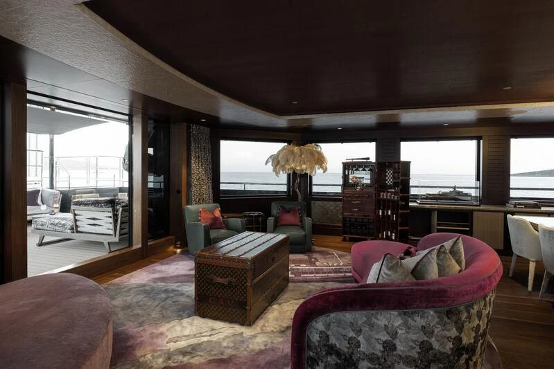 a living room with a couch and a table aboard PINK SHADOW Yacht for Sale