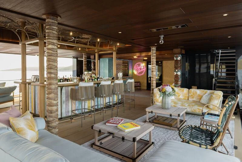 a large living room with a large fireplace aboard PINK SHADOW Yacht for Sale