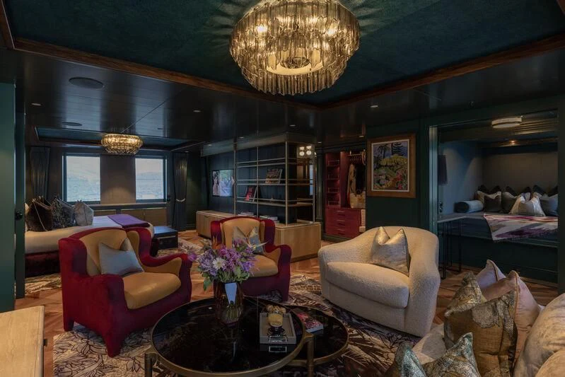 a living room with a large chandelier aboard PINK SHADOW Yacht for Sale