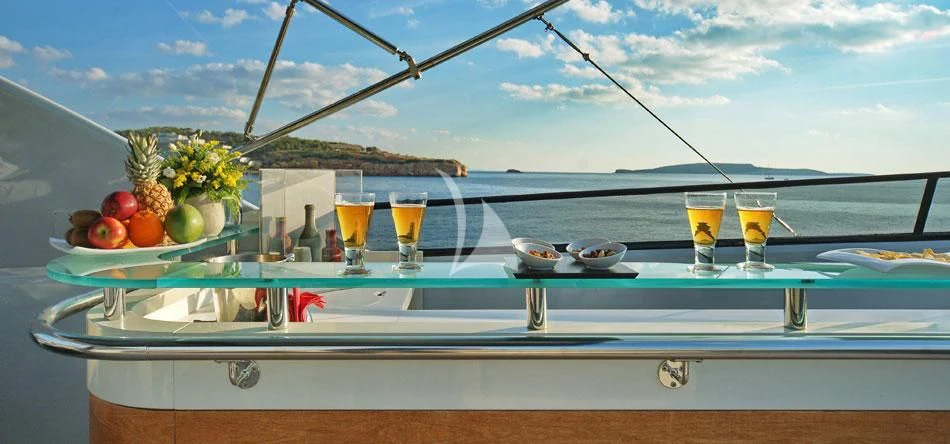 a table with food and drinks on it aboard OBSESION Yacht for Sale