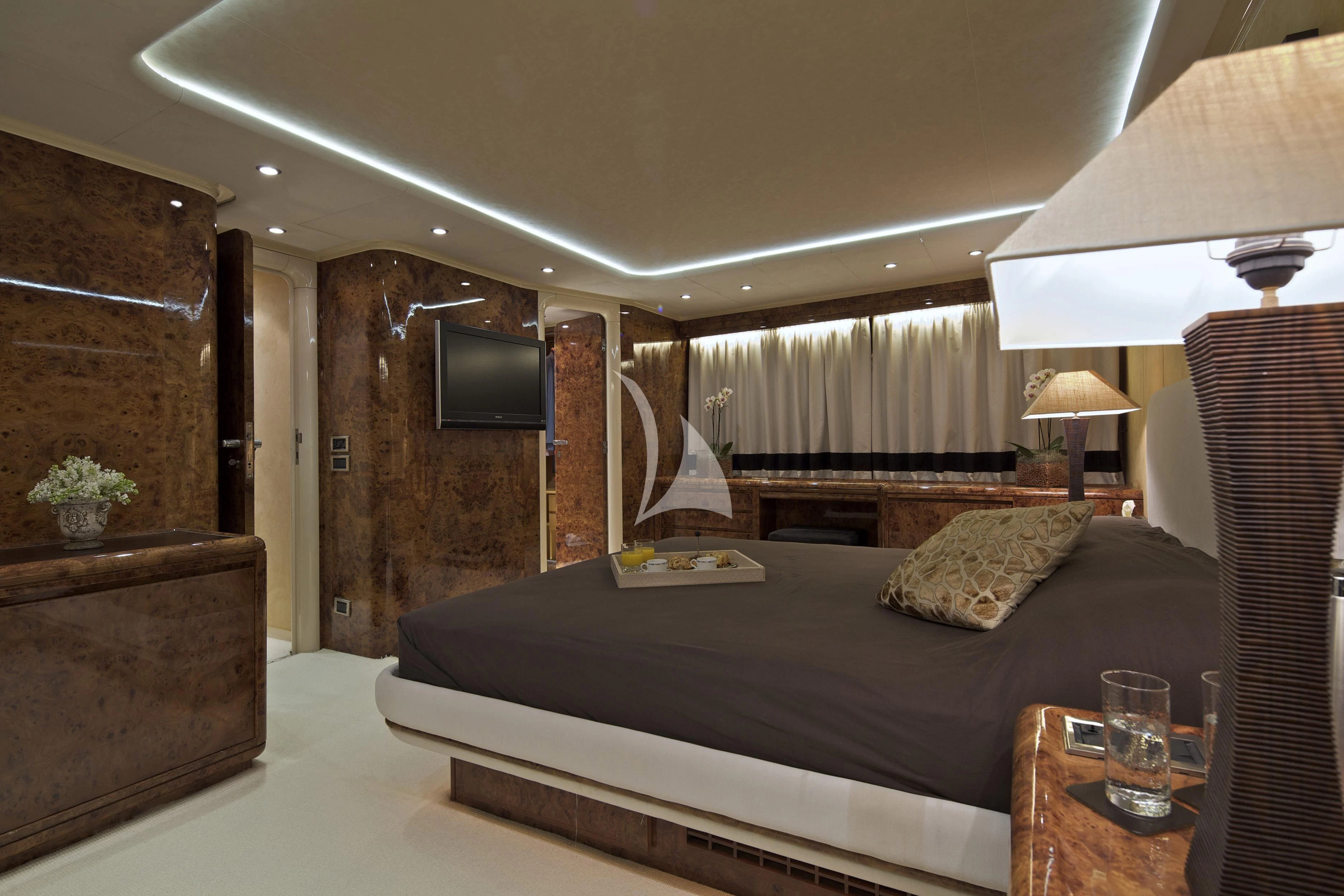 a bedroom with a bed and a tv aboard OBSESION Yacht for Sale