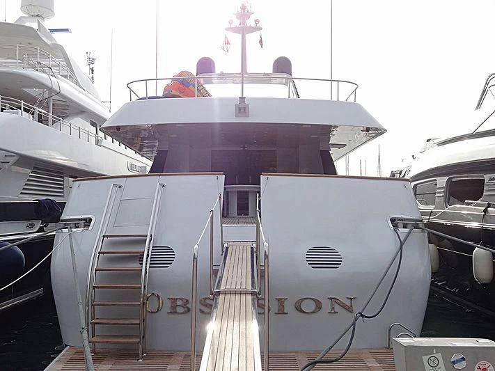 a large white boat with a staircase aboard OBSESION Yacht for Sale