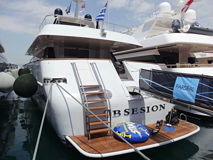 a boat docked at a pier aboard OBSESION Yacht for Sale