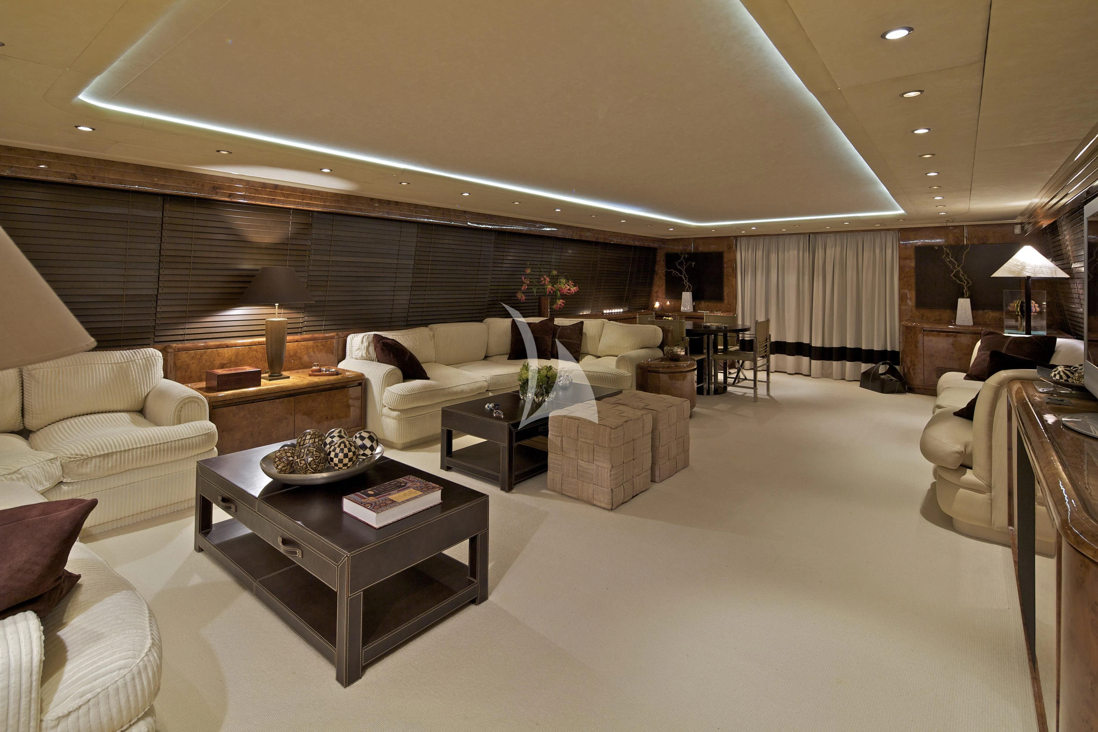 a living room with a large couch and a coffee table aboard OBSESION Yacht for Sale