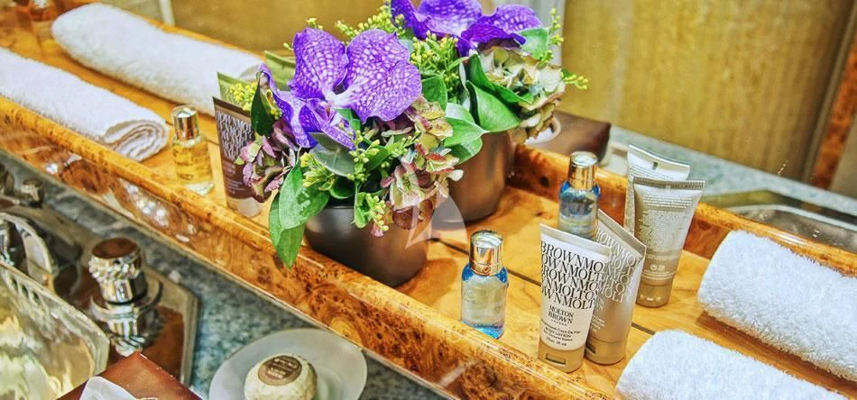 a table with a vase of flowers and candles aboard OBSESION Yacht for Sale