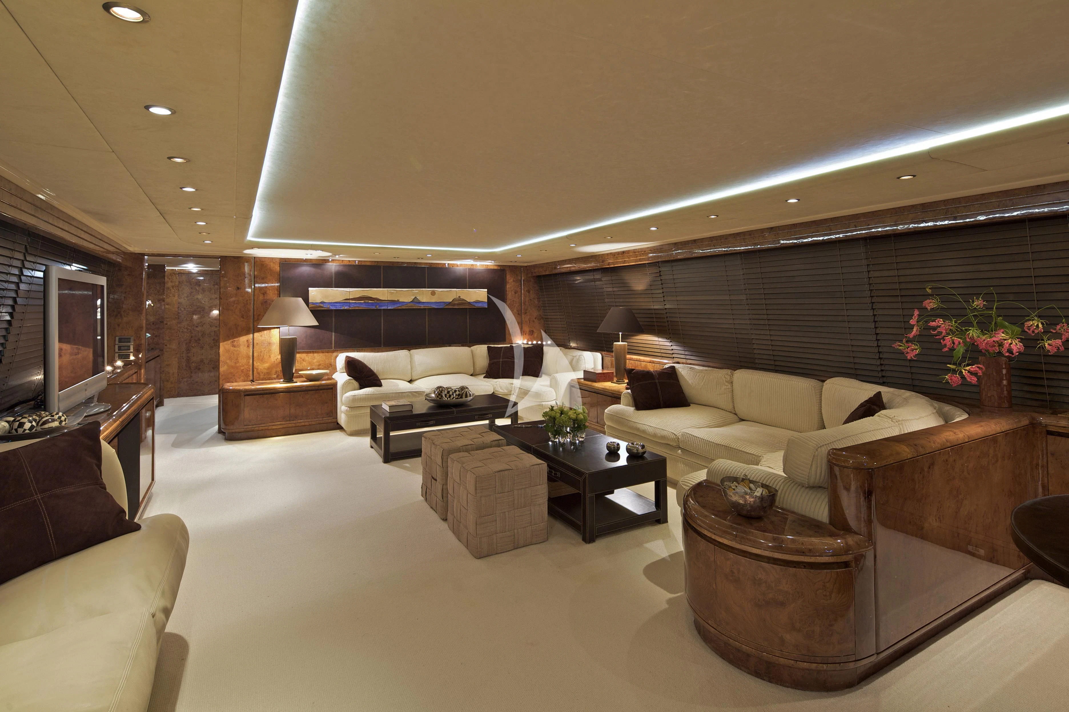a living room with a large couch aboard OBSESION Yacht for Sale