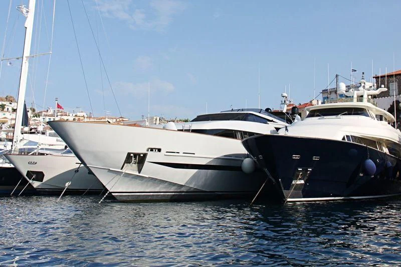 several boats docked at a pier aboard OBSESION Yacht for Sale