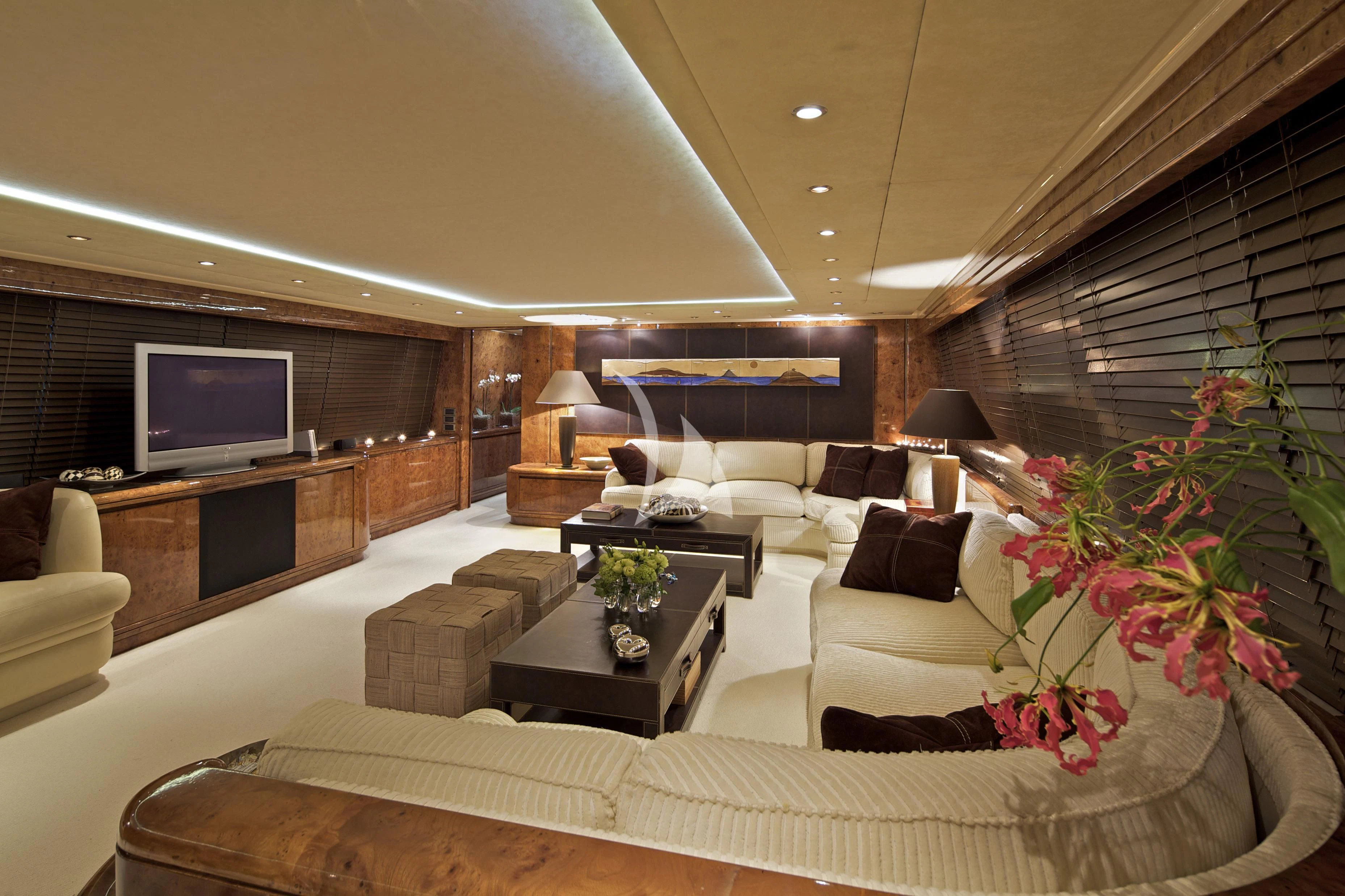a living room with a large screen aboard OBSESION Yacht for Sale