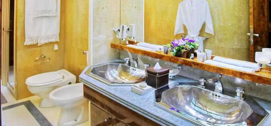 a bathroom with a large mirror aboard OBSESION Yacht for Sale