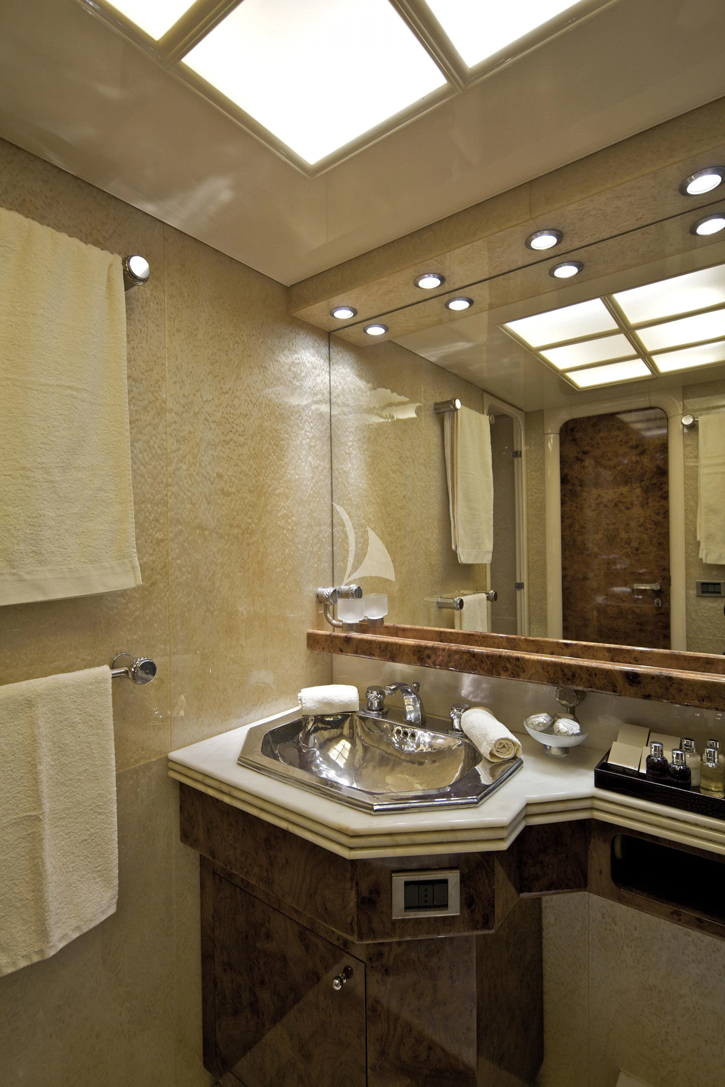 a bathroom with a large mirror aboard OBSESION Yacht for Sale