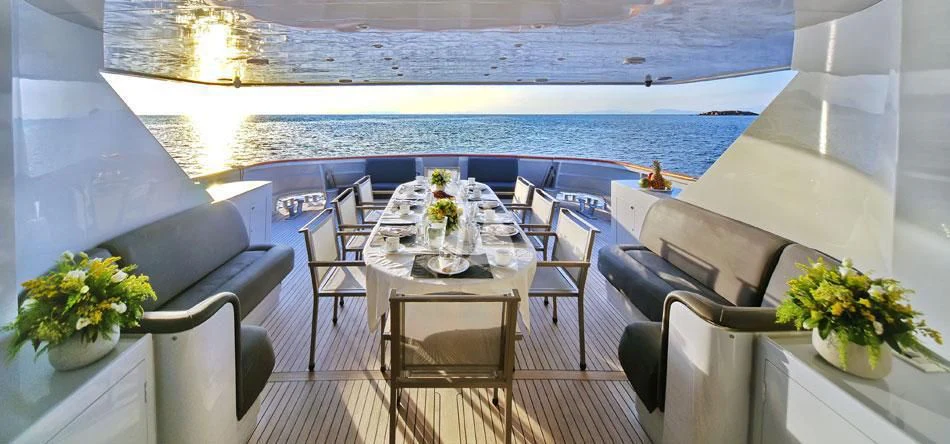 a room with a table and chairs and a large body of water aboard OBSESION Yacht for Sale