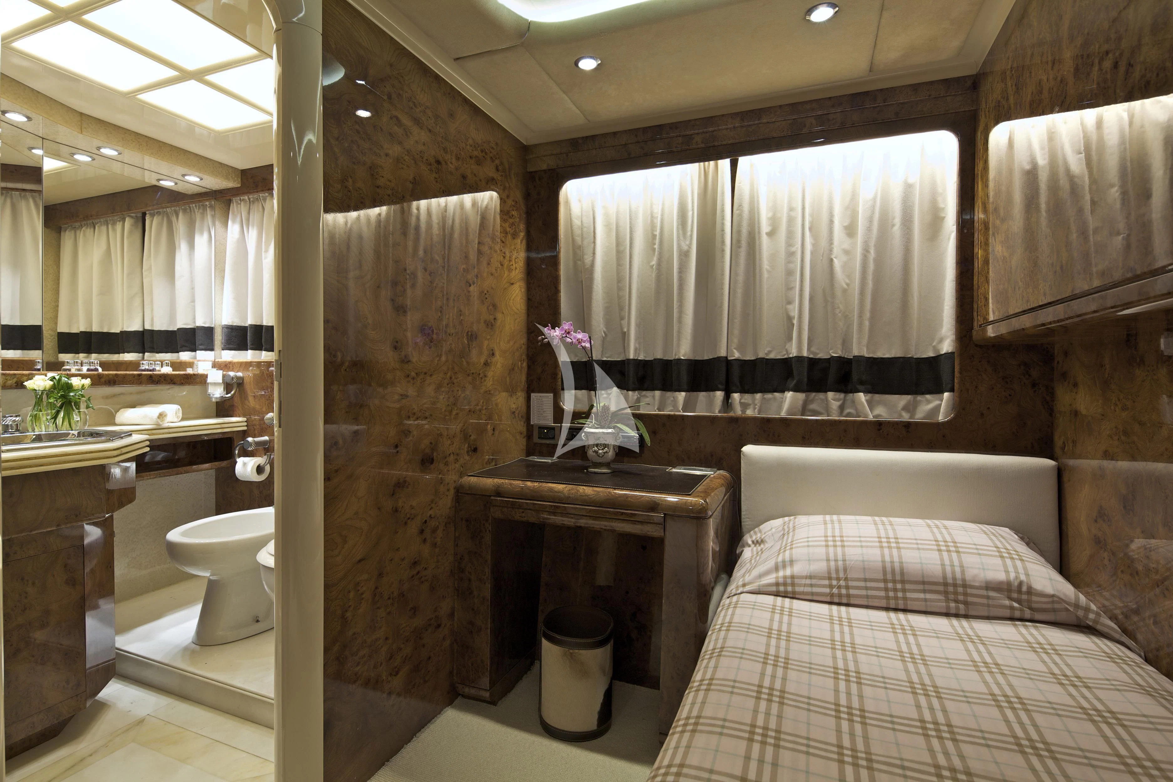 a bathroom with a bed and a sink aboard OBSESION Yacht for Sale