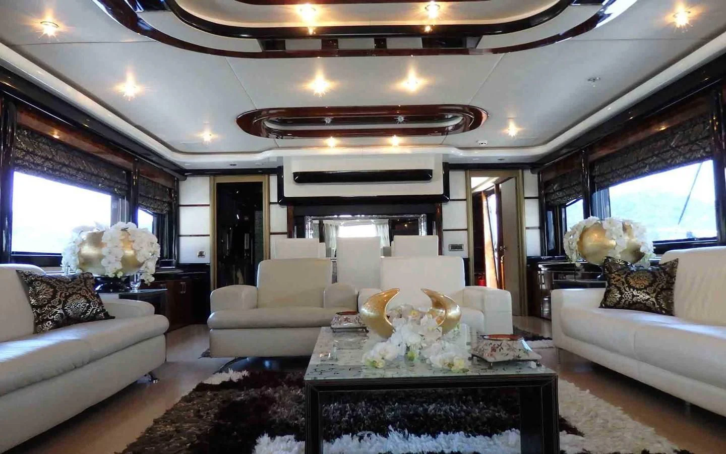 a living room with a large chandelier aboard ETERNITY Yacht for Sale