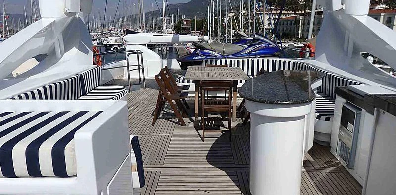 a deck with a table and chairs on it aboard ETERNITY Yacht for Sale