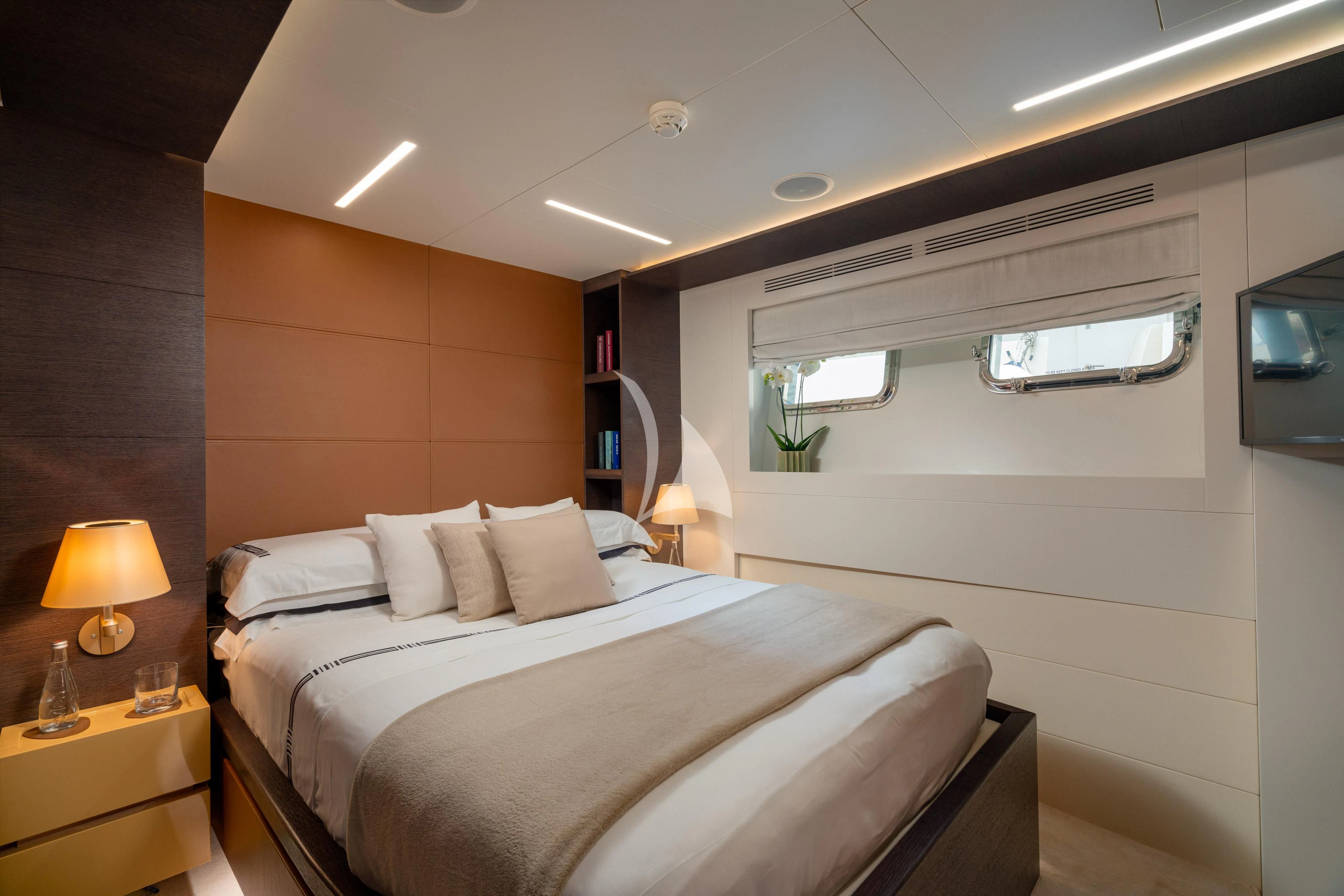 a bedroom with a bed and a desk aboard 55 FIFTYFIVE Yacht for Charter