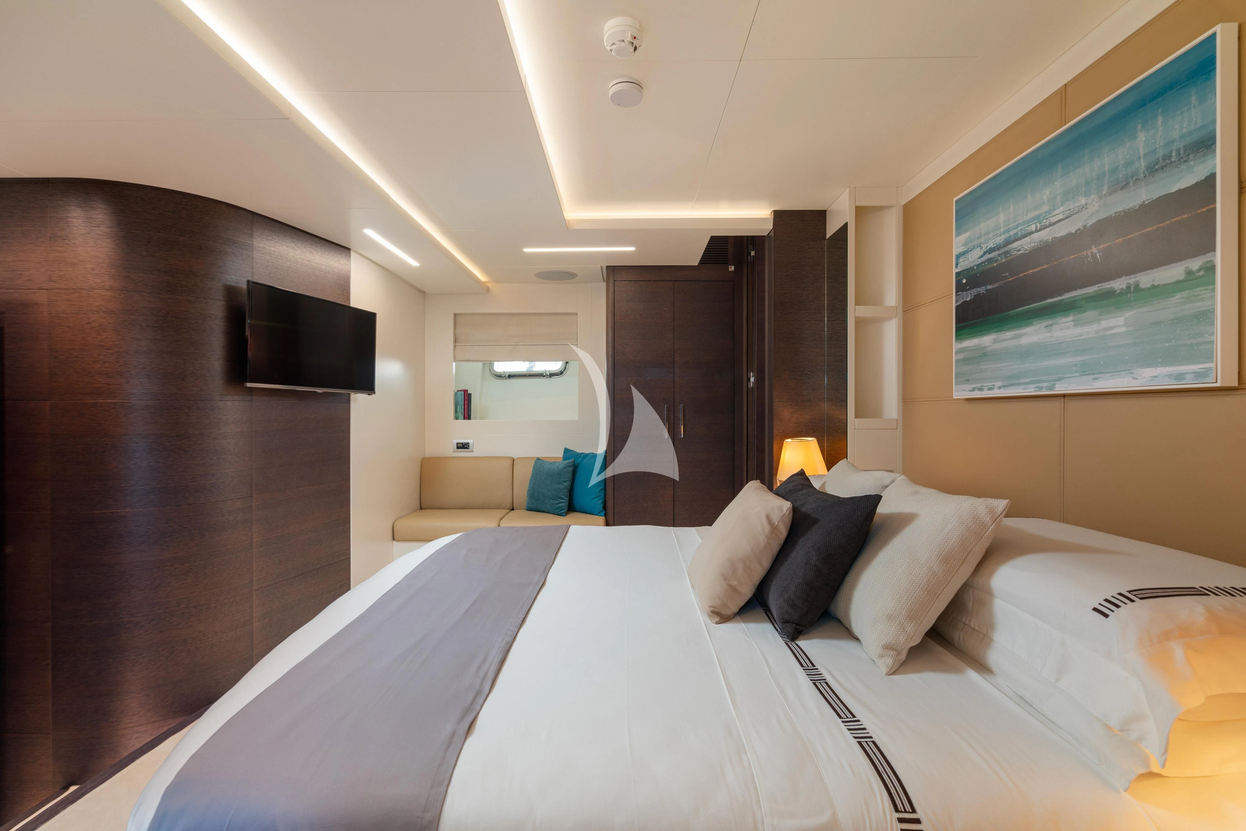 a hotel room with a bed and tv aboard 55 FIFTYFIVE Yacht for Charter