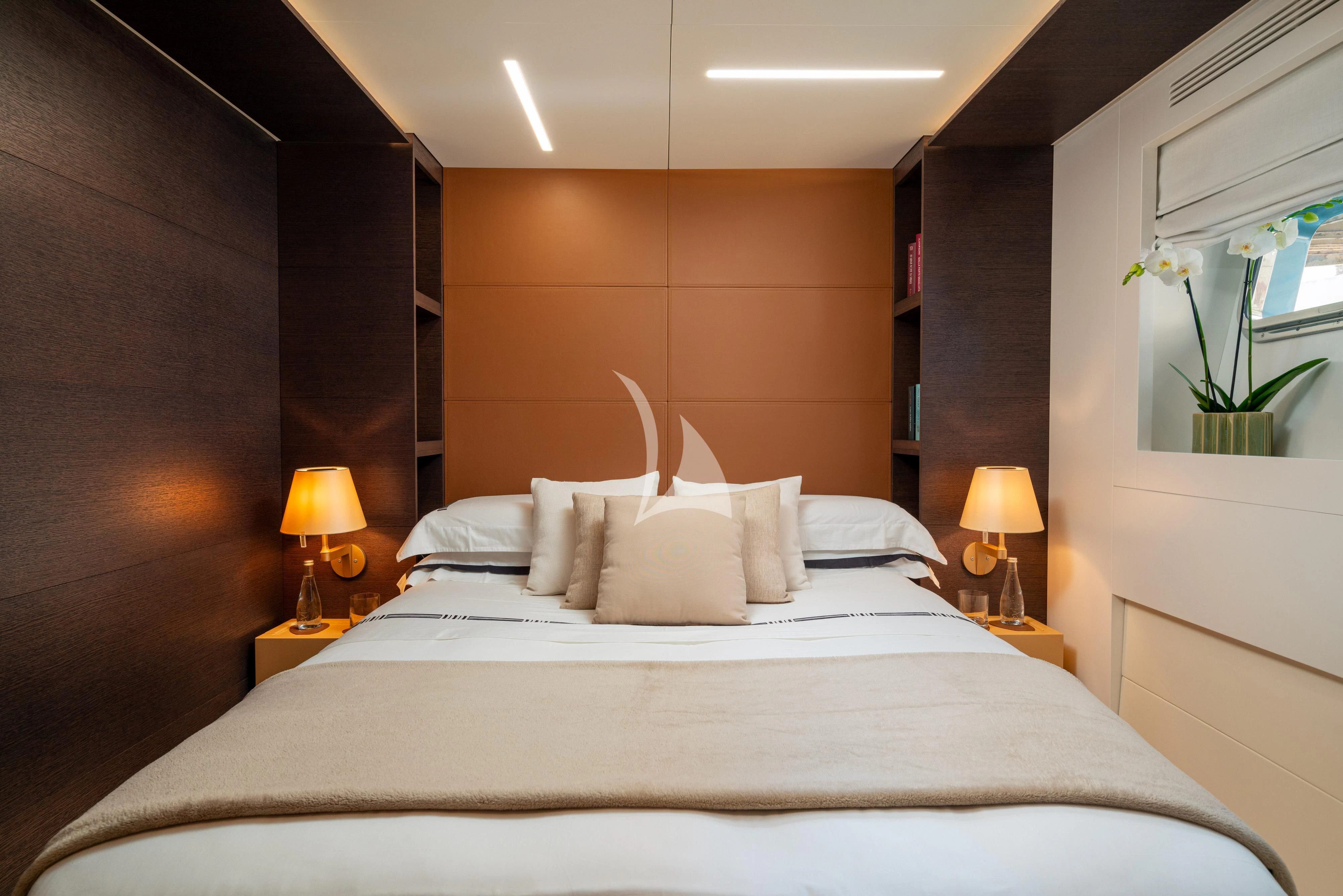 a bed with white sheets and pillows aboard 55 FIFTYFIVE Yacht for Charter