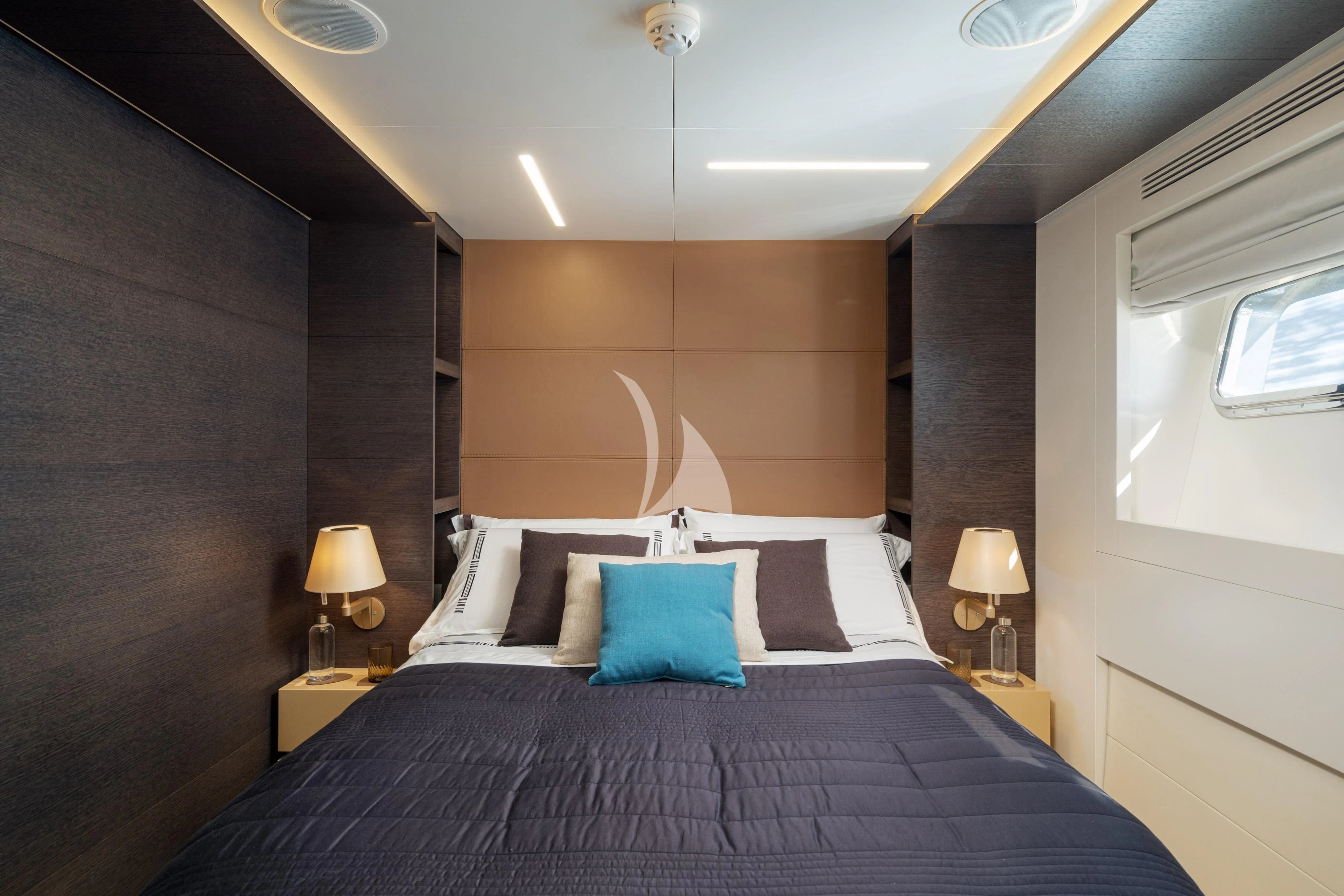a bed with a purple blanket aboard 55 FIFTYFIVE Yacht for Charter