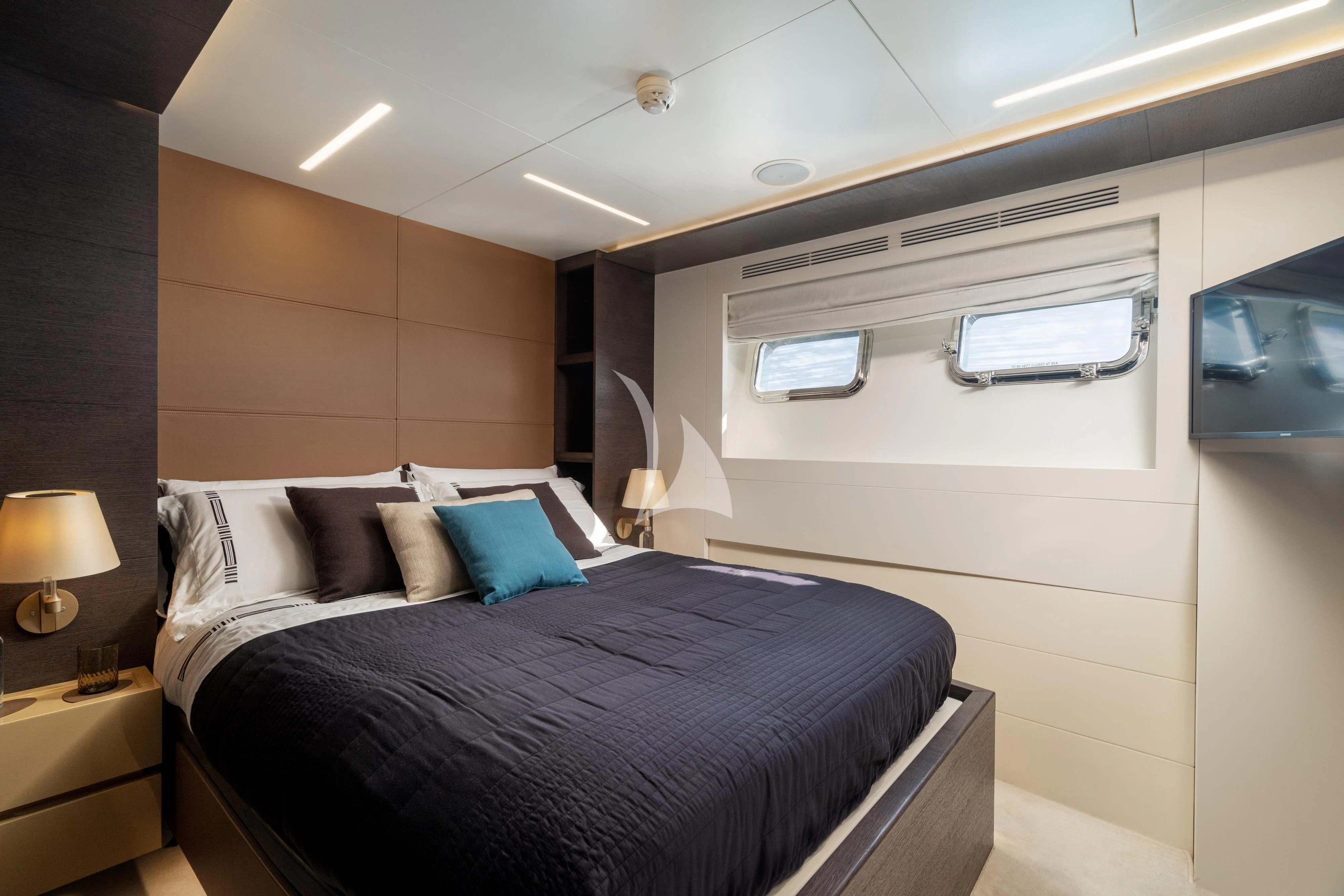 a bedroom with a bed and a television aboard 55 FIFTYFIVE Yacht for Charter