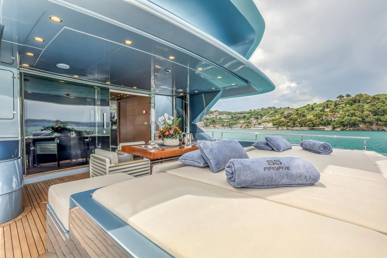 a deck with a pool and a deck and a view of the water aboard 55 FIFTYFIVE Yacht for Charter