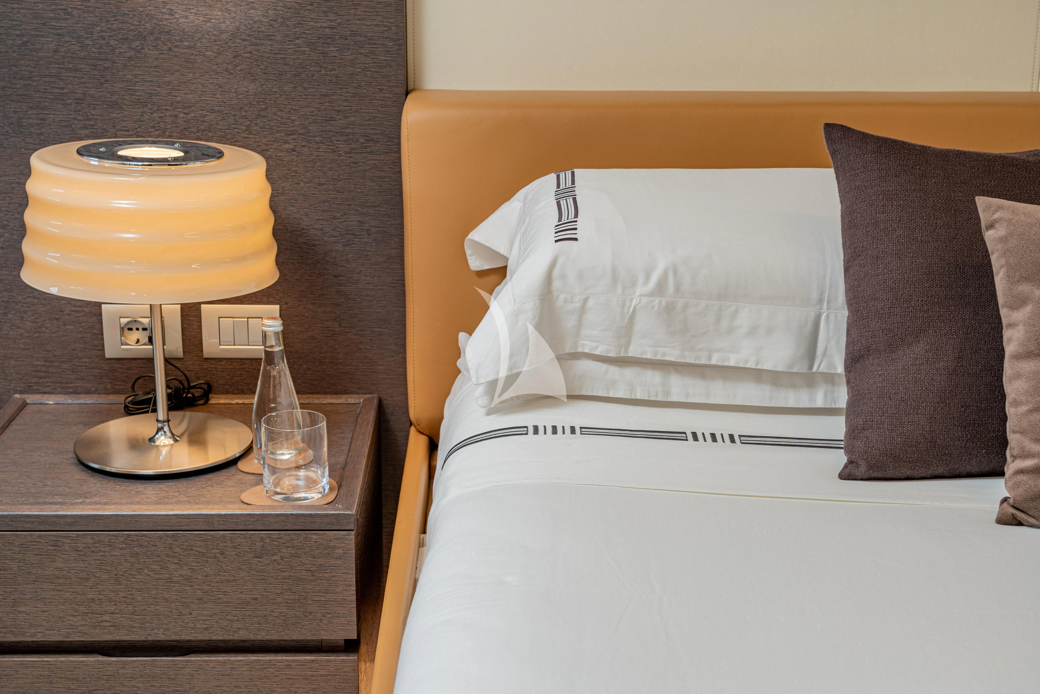 a hotel room with a bed and coffee table aboard 55 FIFTYFIVE Yacht for Charter