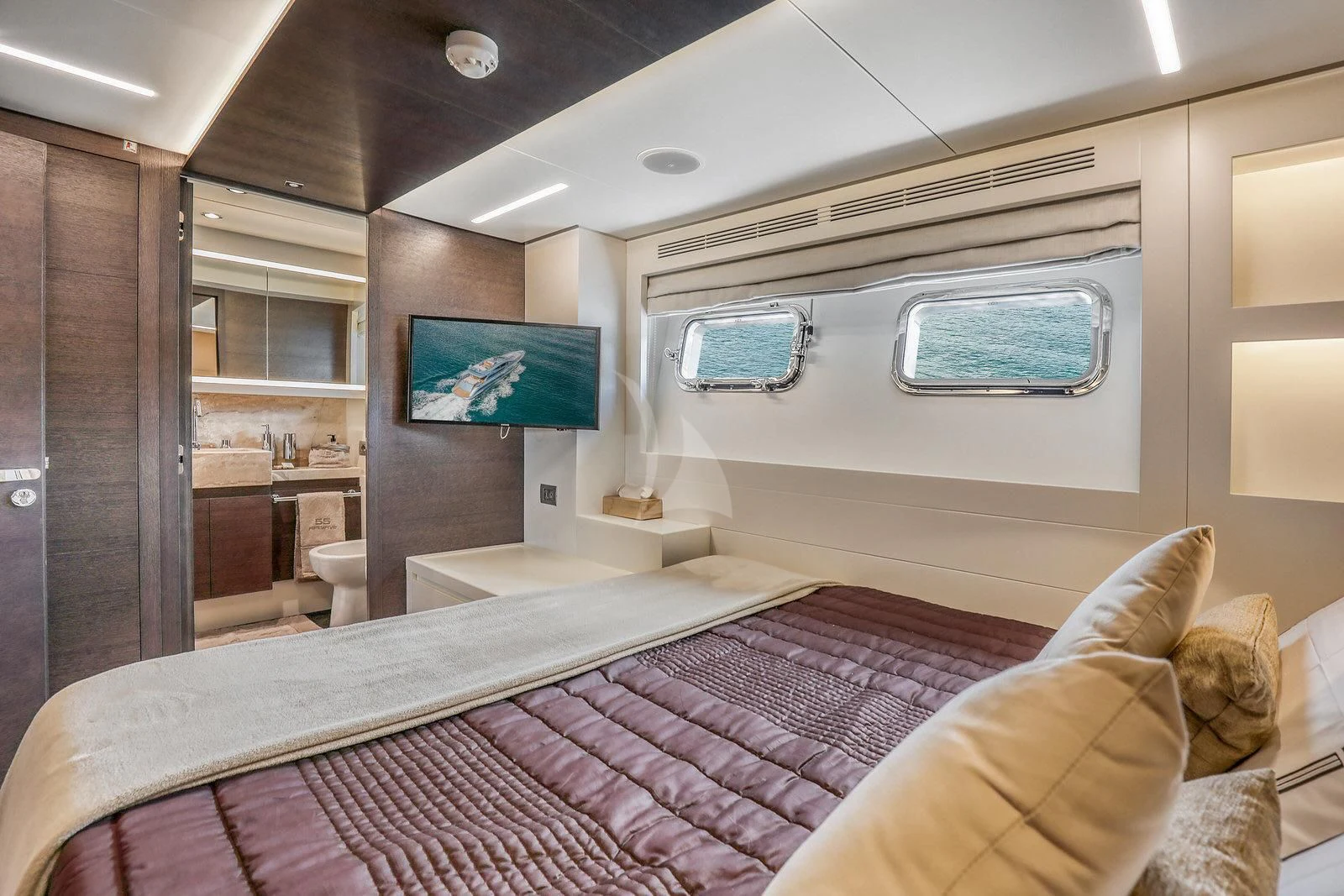 a room with a bed and a tv on the wall aboard 55 FIFTYFIVE Yacht for Charter