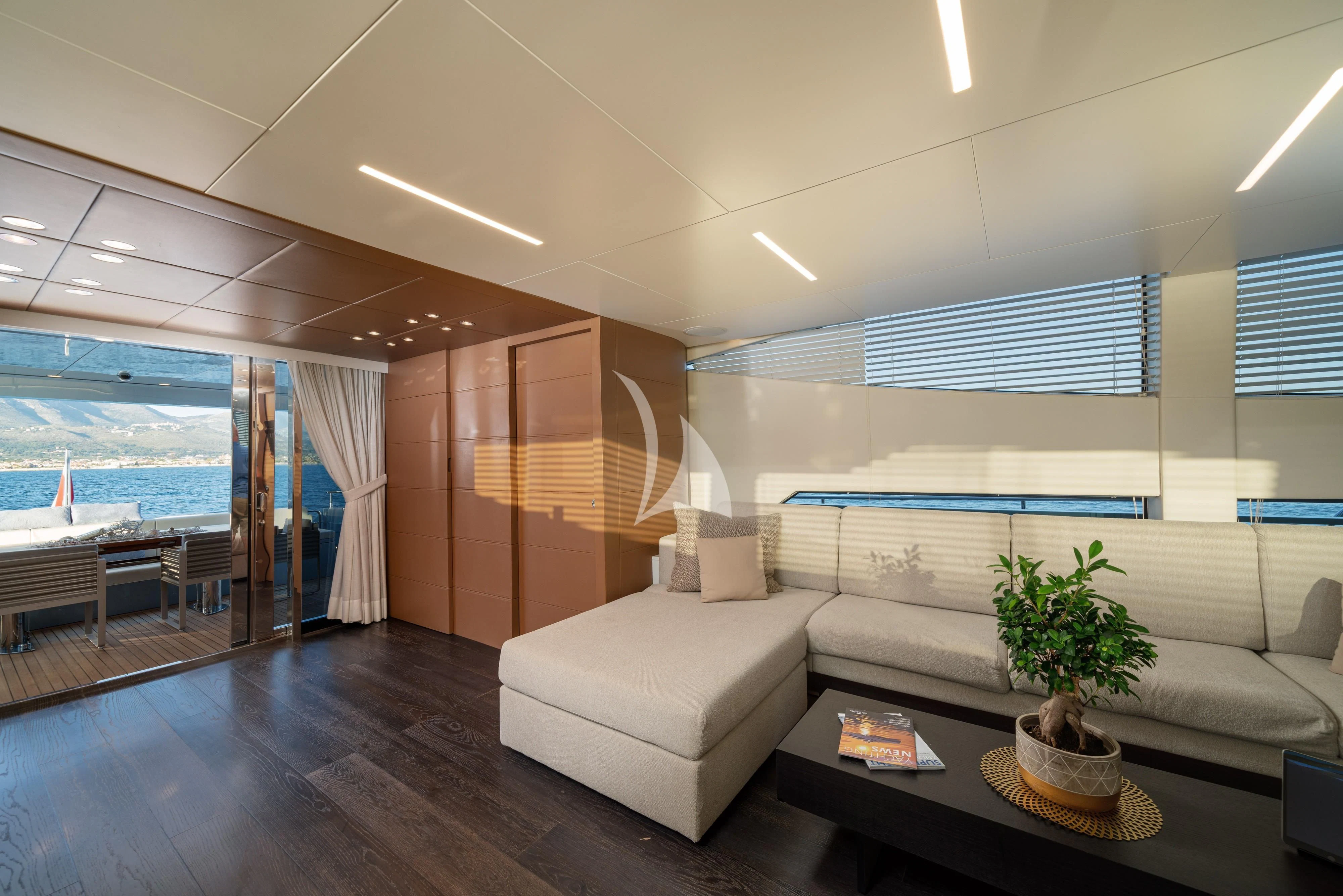 a living room with a large window aboard 55 FIFTYFIVE Yacht for Charter